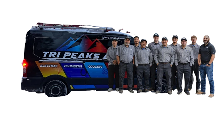 Eight men in work uniforms stand next to a Tri Peaks service van labeled electric, plumbing, and cooling—showcasing the team behind our about us story.